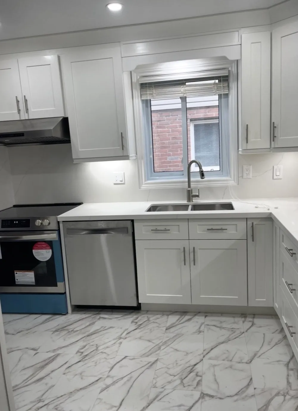 Renovated white kitchen with quartz counters in London, Ontario